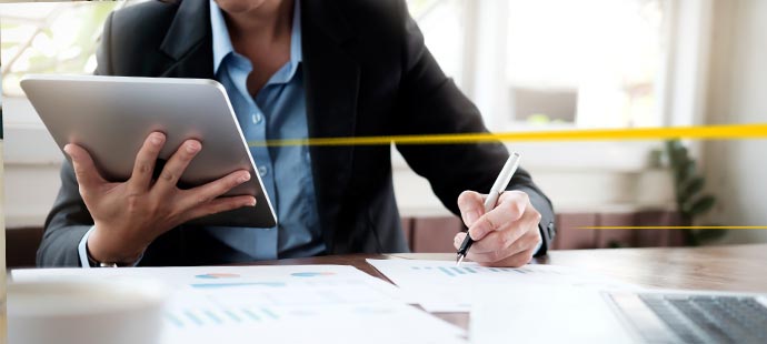 LGI executive with tablet at the desk